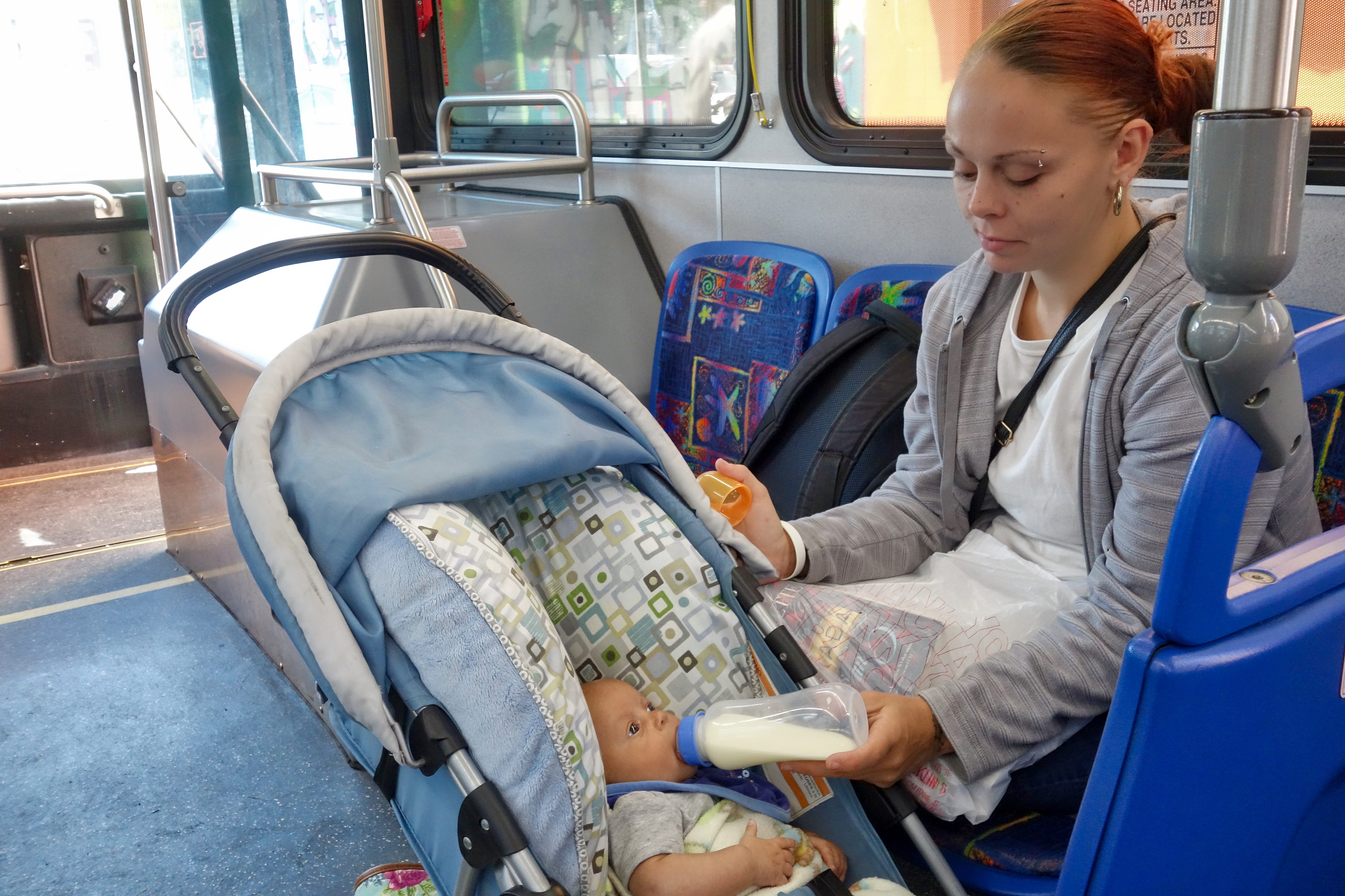 Tia Hosler, along with her son, Marsean, rides the bus home from treatment in Fort Wayne, Indiana. Every day Hosler, who's recovering from addiction, juggles bus schedules, doctors appointments, random drug testing and job hunting.