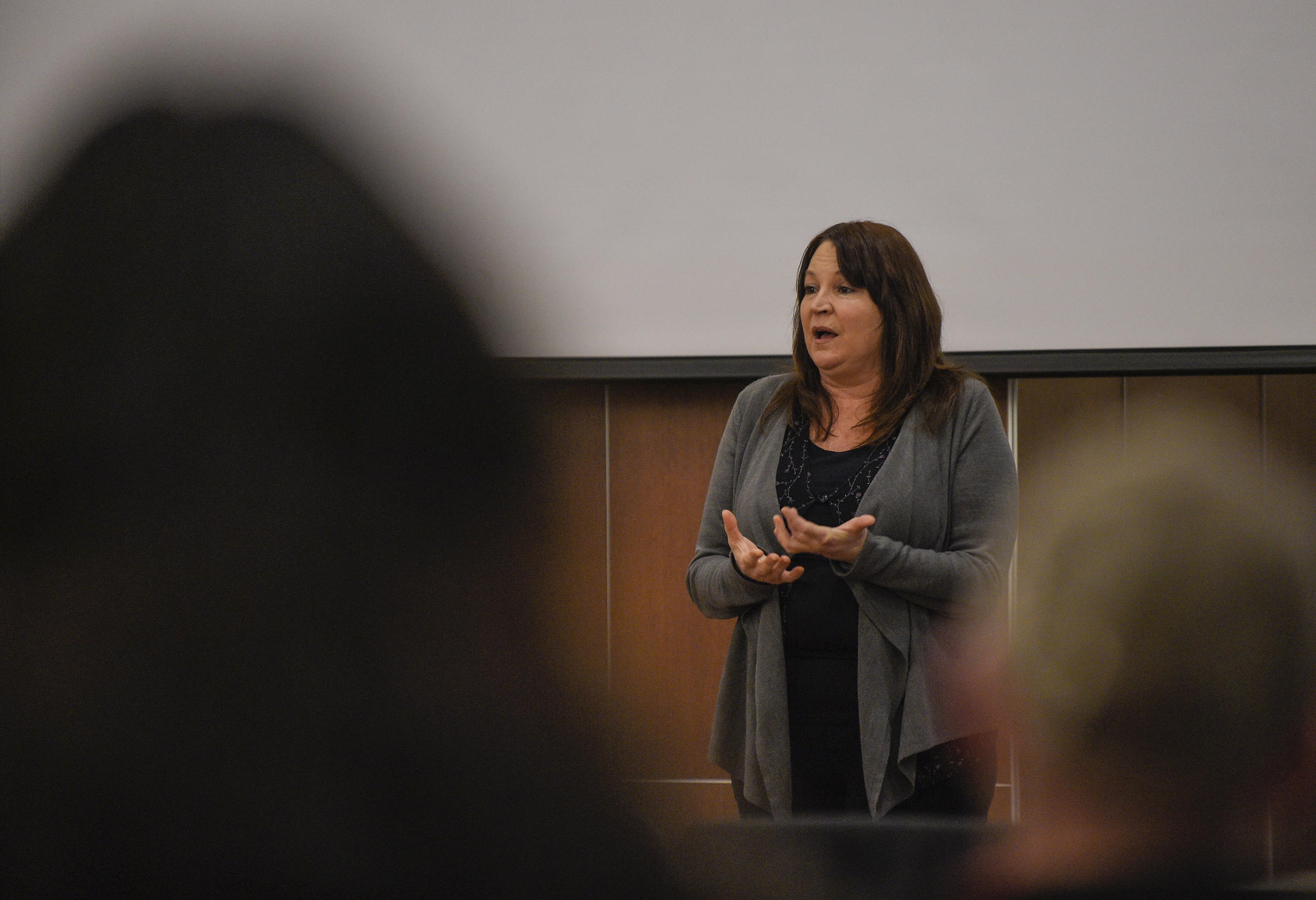 Valerie stands in front of a lecture hall.