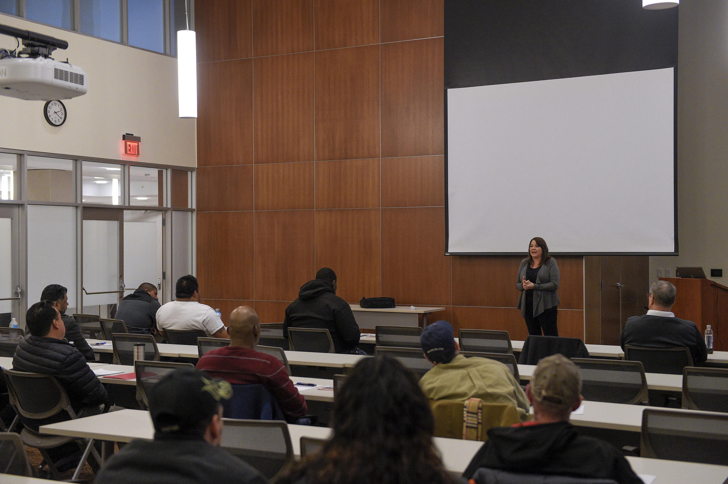 Valerie stands in front of a lecture hall.